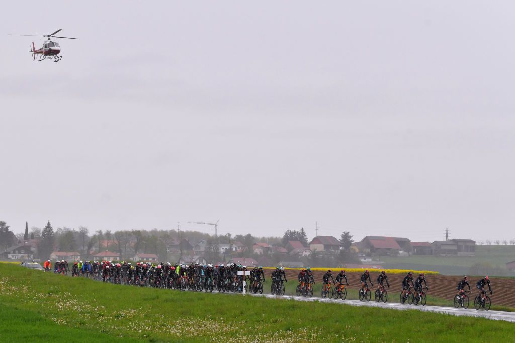 ESTAVAYER SWITZERLAND APRIL 30 The Peloton passing through Lully Village during the 74th Tour De Romandie 2021 Stage 3 a 1687km stage from Estavayer to Estavayer Helicopter Landscape Rain TDR2021 TDRnonstop UCIworldtour on April 30 2021 in Estavayer Switzerland Photo by Luc ClaessenGetty Images