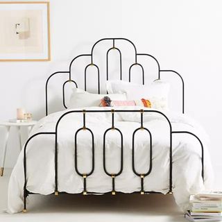 Anthropologie Deco Bed Frame against a white wall.