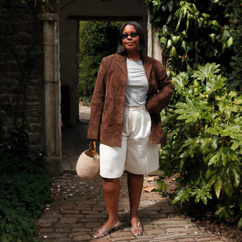 A photo of @styleidealist standing by plants in a garden