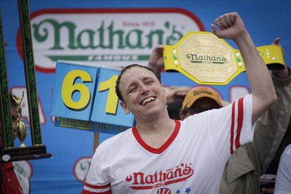 Joey Chestnut celebrates eating 70 hot dogs on Monday.