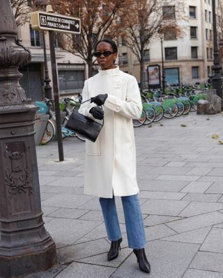 Influencer wears jeans and boots.