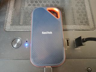 A black and orange SanDisk Extreme PRO Portable SSD