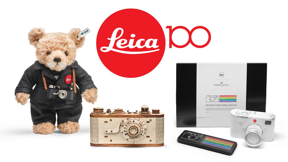 A selection of Leica 100th anniversary items, including &quot;Ernst&quot; Steiff bear, wooden camera puzzle, and Leica M coloring kit