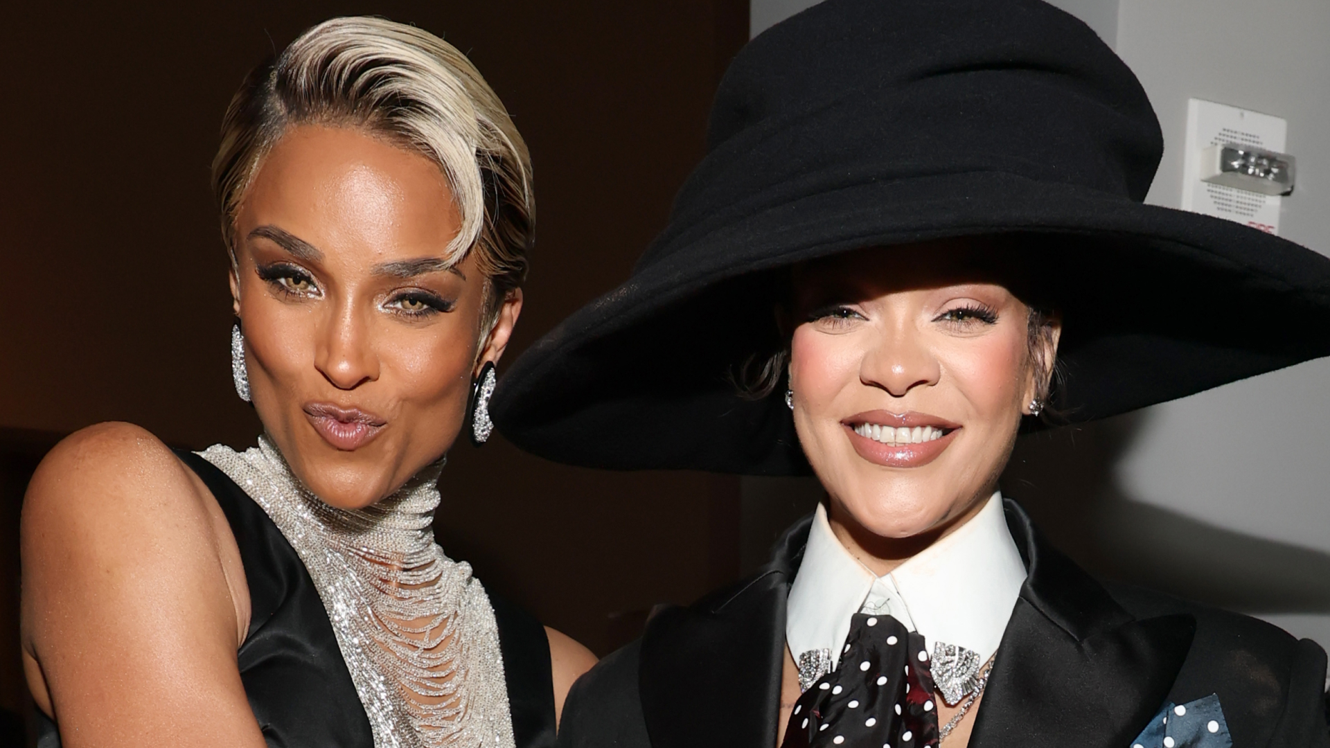 Ciara in a black and silver gown and Rihanna in a suit and black large hat at the 2025 Met Gala
