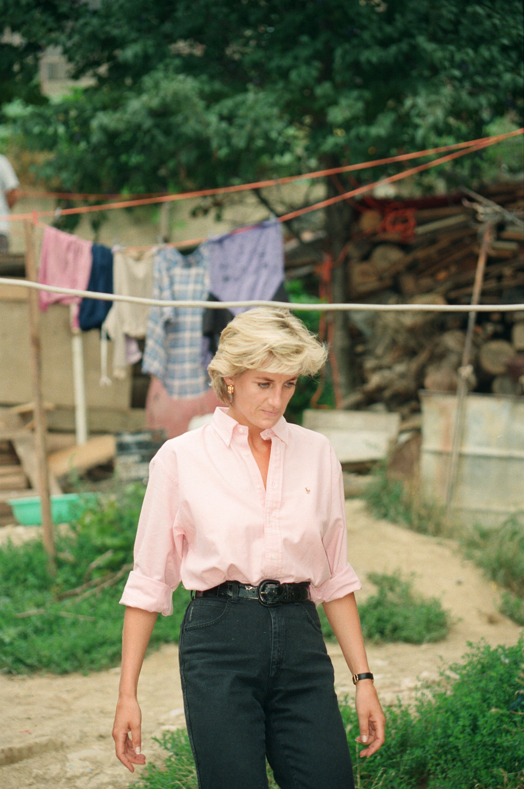 Princess Diana wearing a pink shirt and jeans