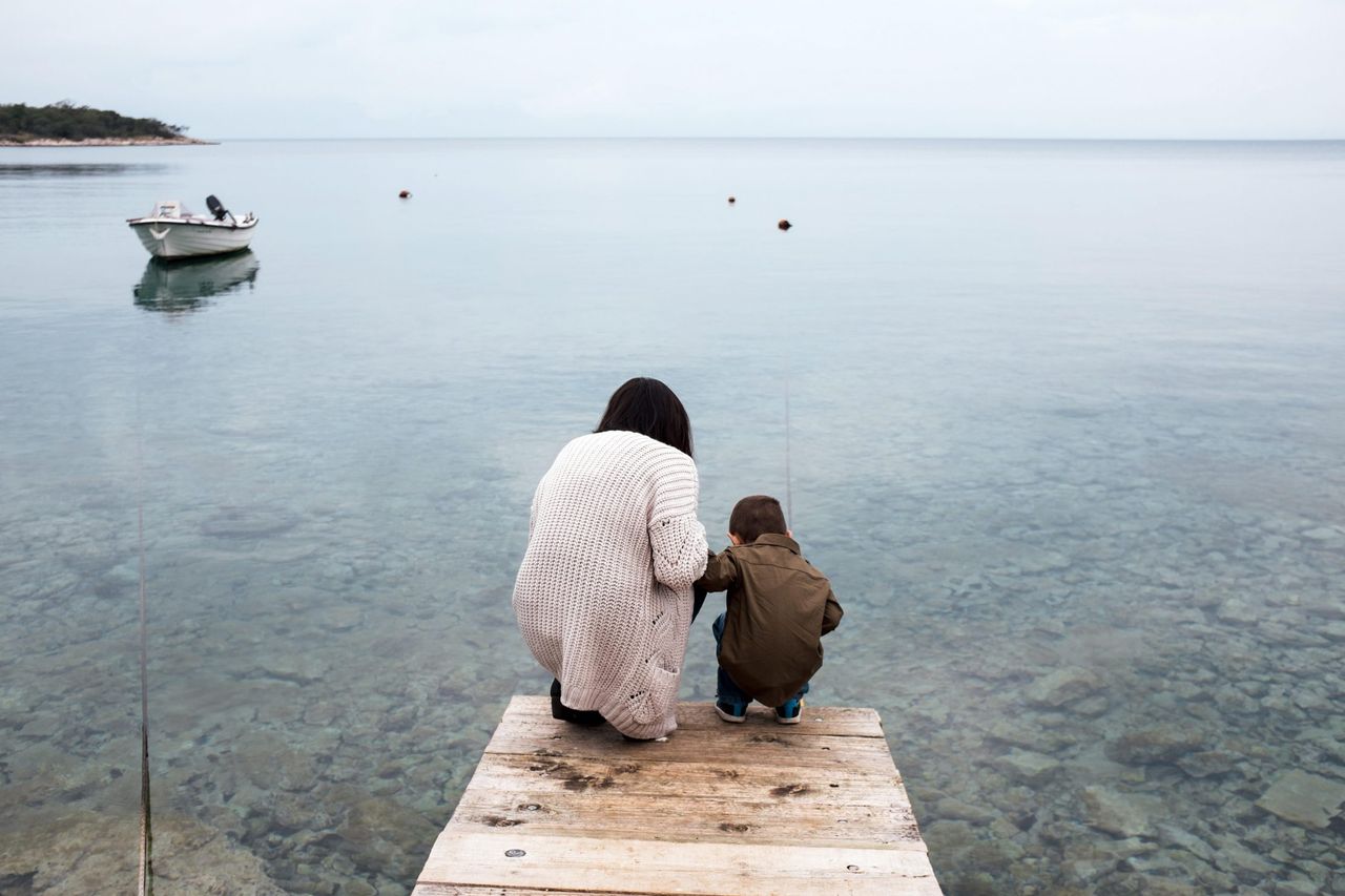 Mother and her son looking for a fish