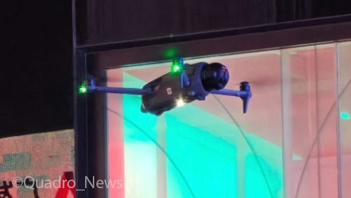 Crop of what looks like a DJI Mavic 4 drone (with rounded camera end) flying indoors from @Quadro_News twitter