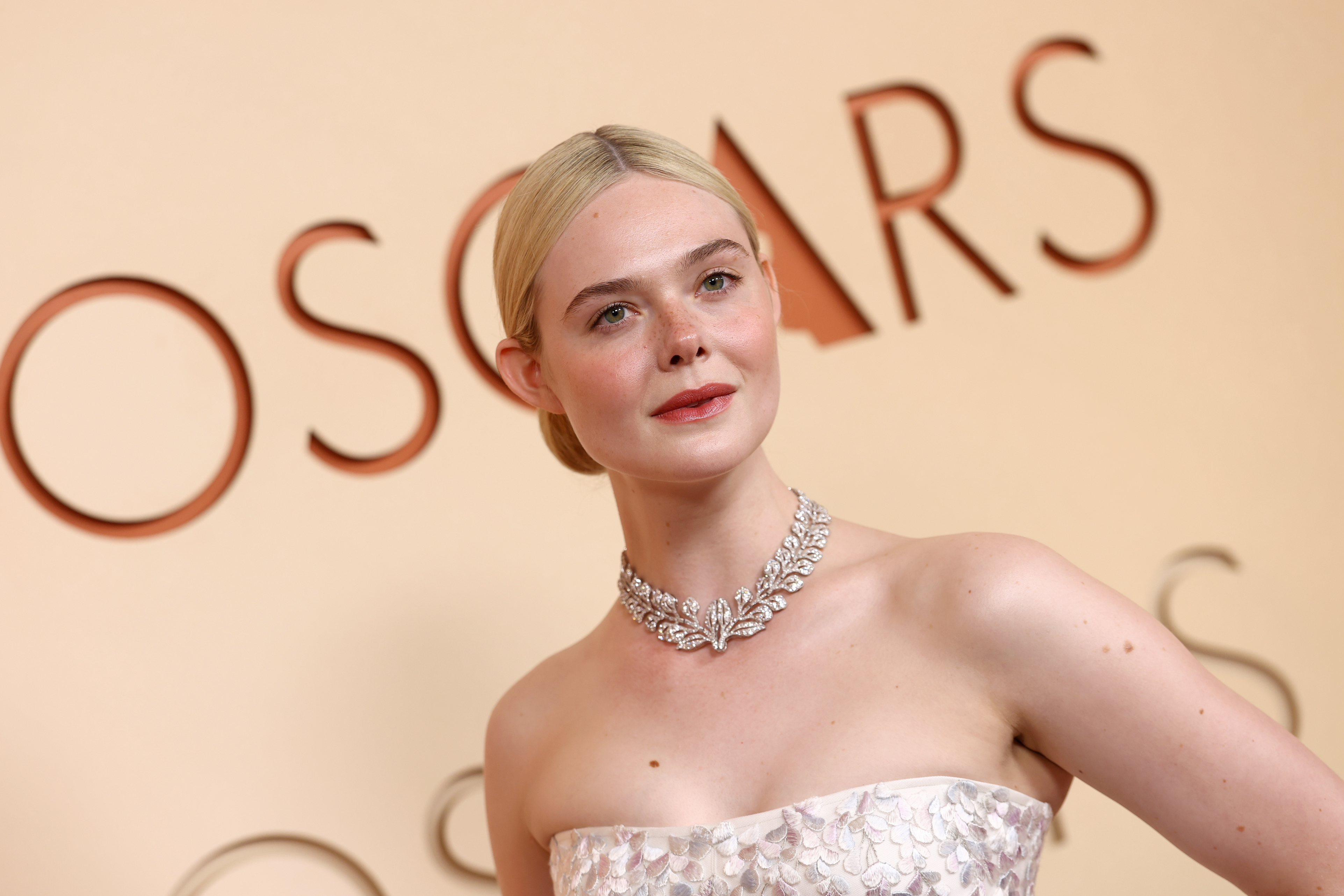elle fanning in a diamond necklace and low bun