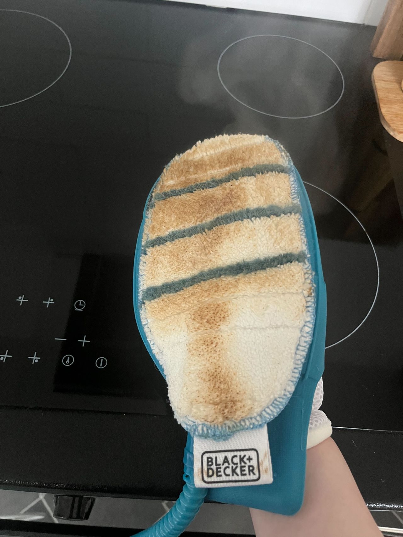 The greasy marks from an oven door on a steam cleaning mitt