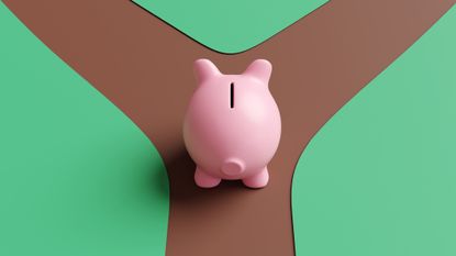 a piggy bank approaching a fork in the road with two paths