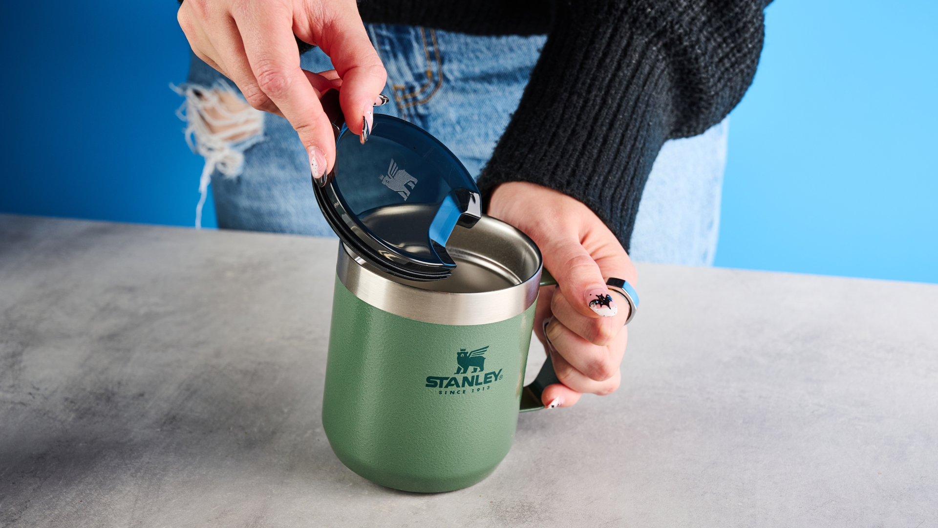 the stanley perfect brew pour over coffee maker in green, photographed with its companion travel mug and with the metal built in filter