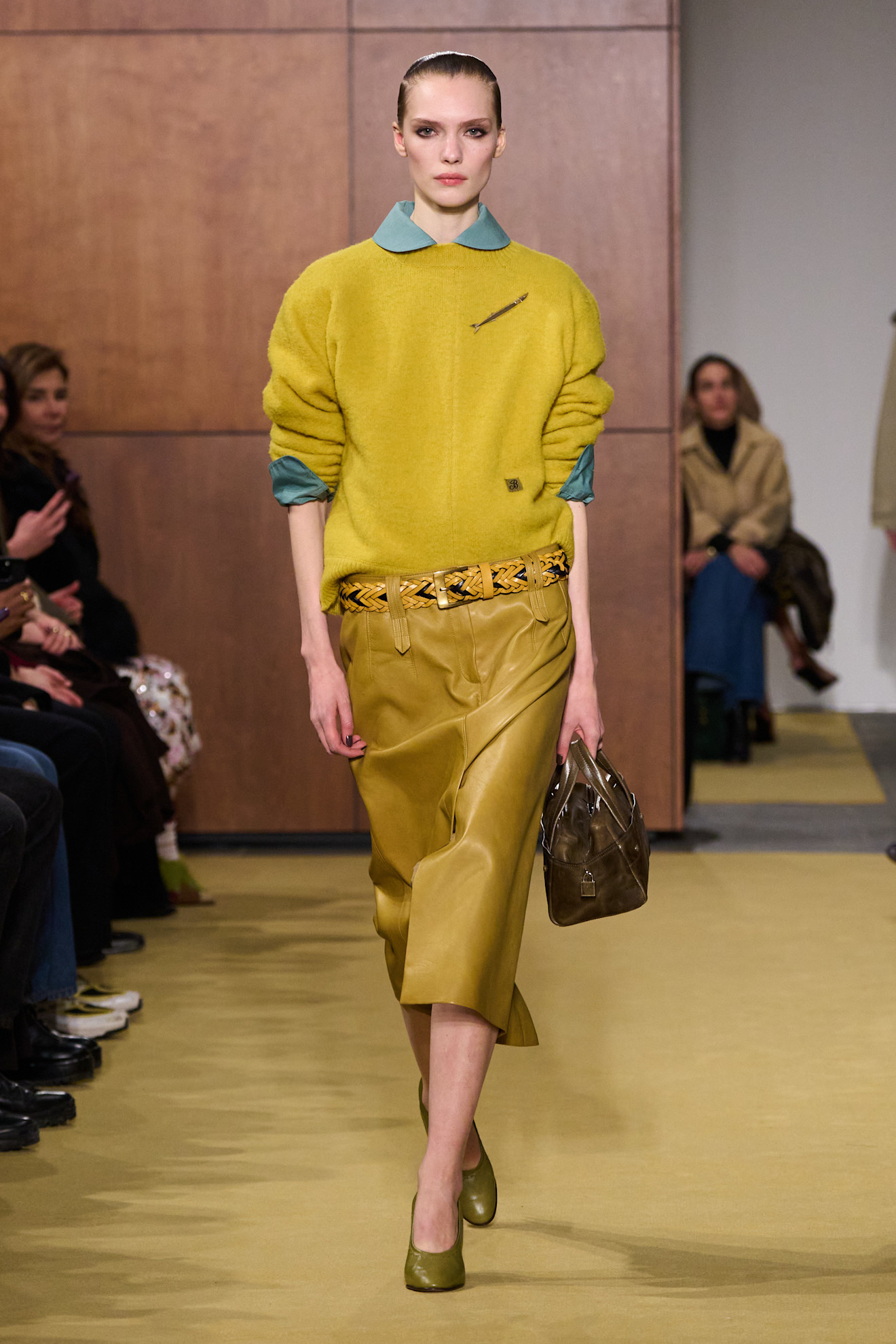 A model wore the mustard yellow color trend on the Tory Burch Fall 2026 runway