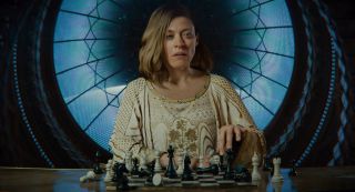 A lady plays chess