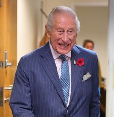 King Charles wearing a blue suit laughing