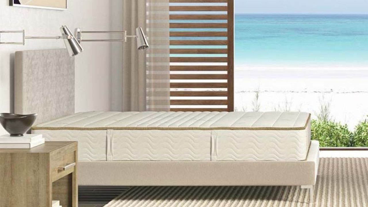 Saatva Zenhaven Natural Latex Mattress against a window with a sea view.