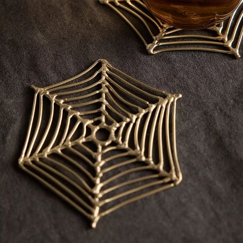 Brass coaster set in the shape of delicate spider webs