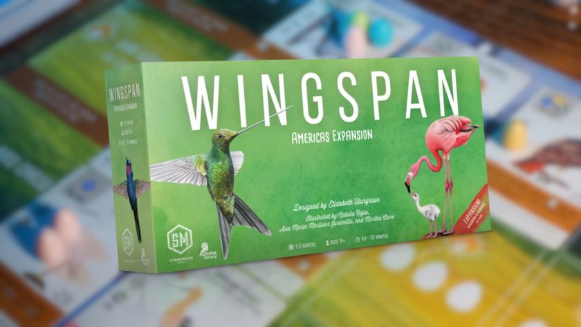 Wingspan Americas Expansion box over a blurred image of the Wingspan board and pieces laid out on a table