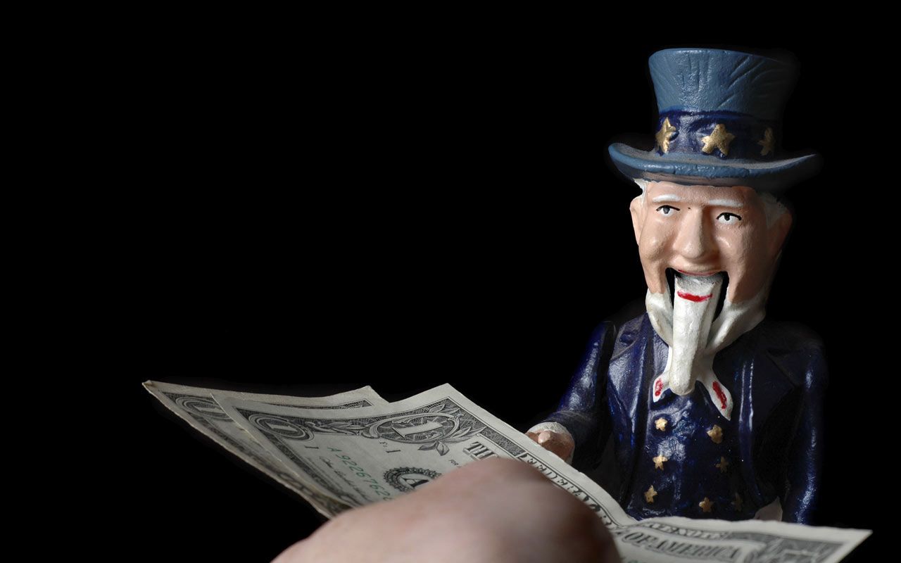 picture of a person handing money to an Uncle Sam bank