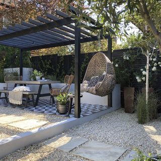 patio area with pergola and wooden table