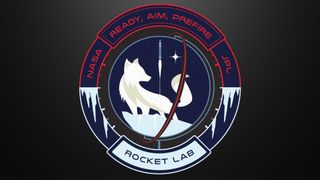 a mission badge showing the white silhouette of an arctic fox against a dark blue background. a white silhouette of a rocket lifts off in the background