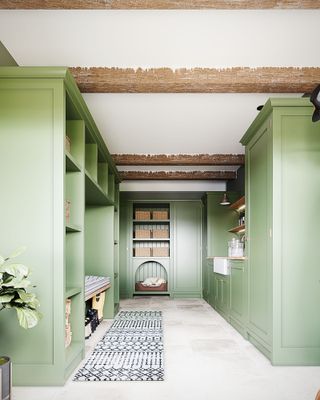 green boot room and utility room with seating and sink