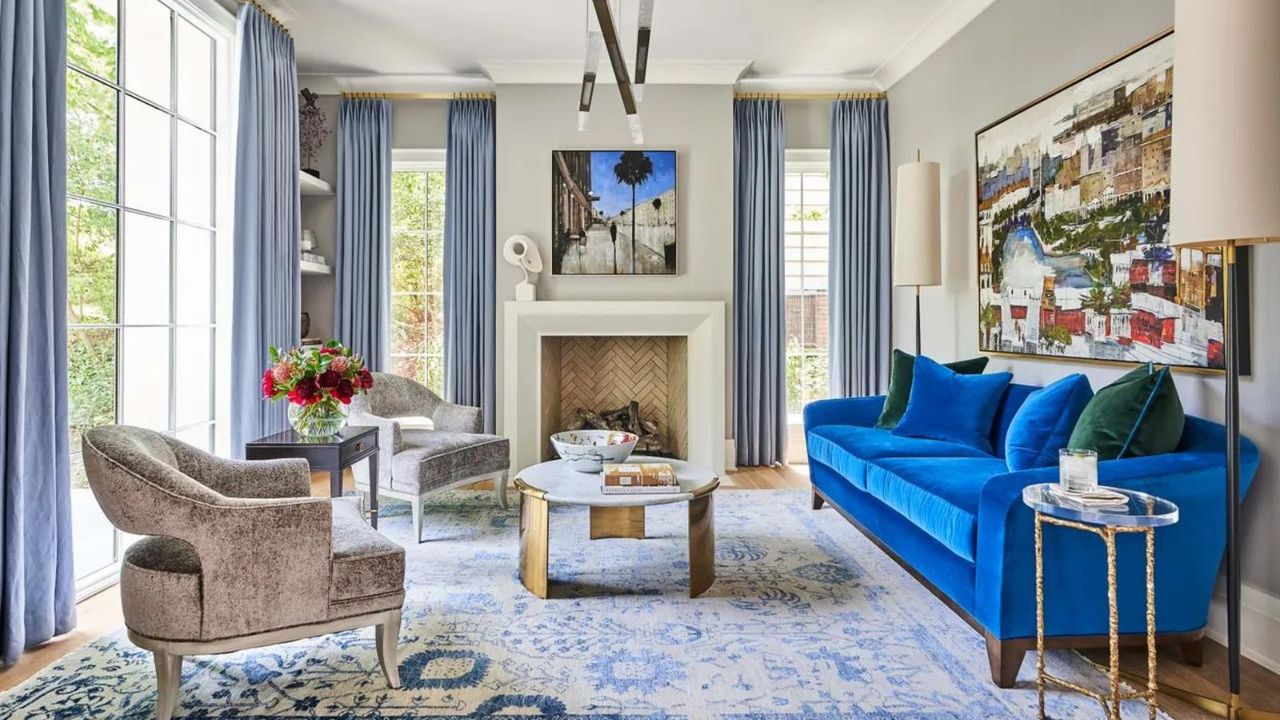 Blue and white living room with bold blue velvet sofa