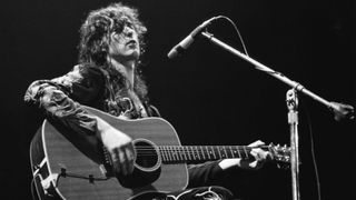 Jimmy Page performing with acoustic guitar