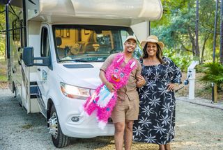 Alison Hammond and son Aidan standing by a campervan with a pinata