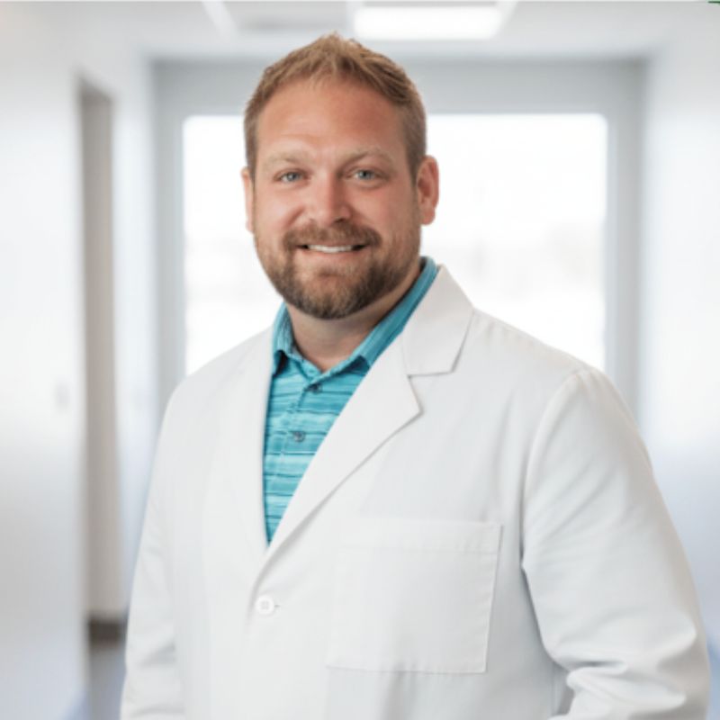 Man in lab coat poses for profile image
