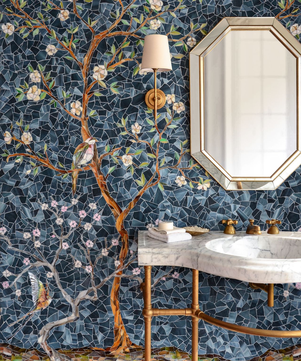 A bold powder room with a botanical mosaic tile mural on the walls