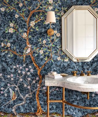 A bold powder room with a botanical mosaic tile mural on the walls