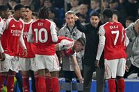 Mikel Arteta speaks with his Arsenal players during a stoppage against Brighton