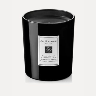 scented candle in black jar with white label