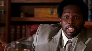 Harold Perrineau as Michael in Lost, wearing a suit and looking mad about something