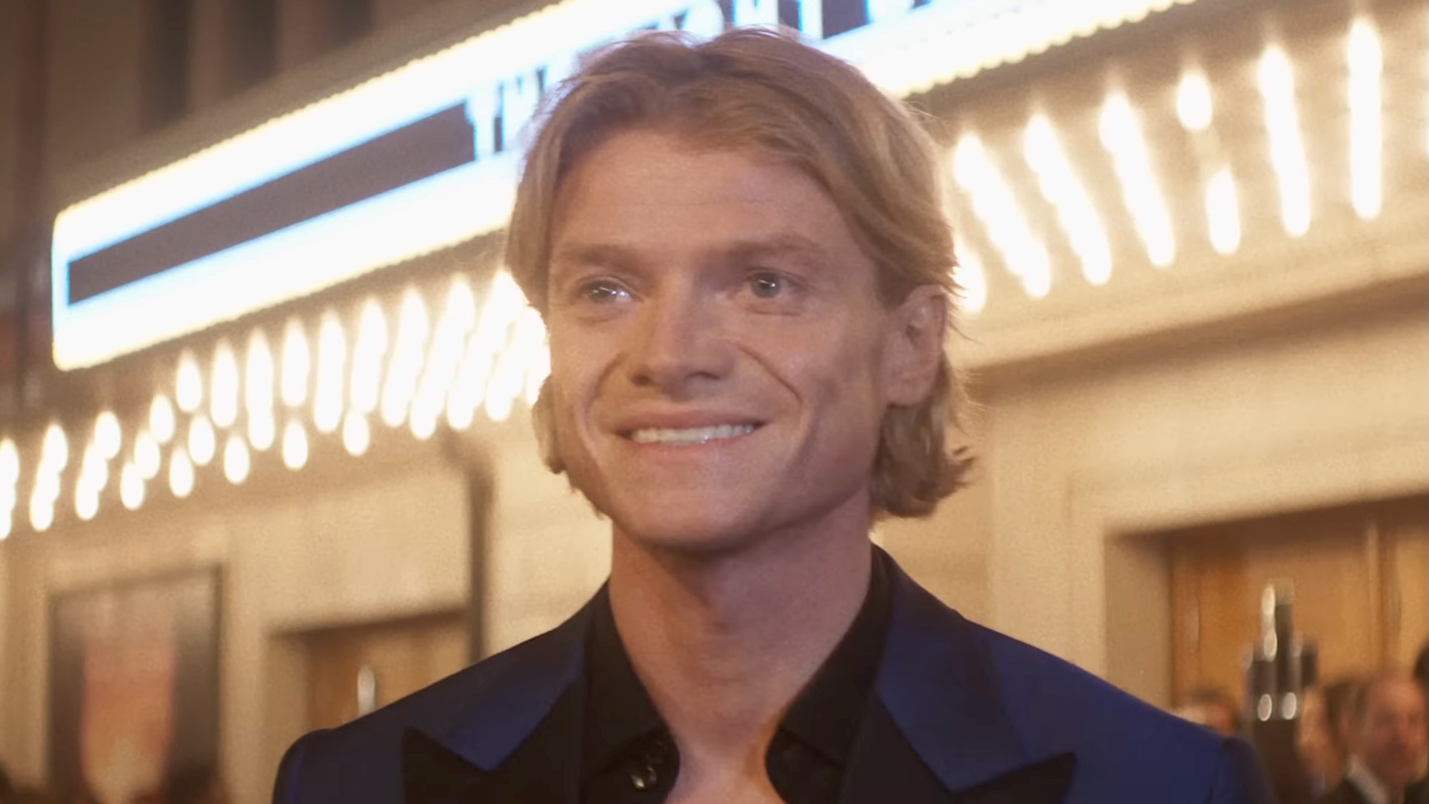 Matt Hagen smiling standing in front of theater during movie premiere red carpet in Clayface