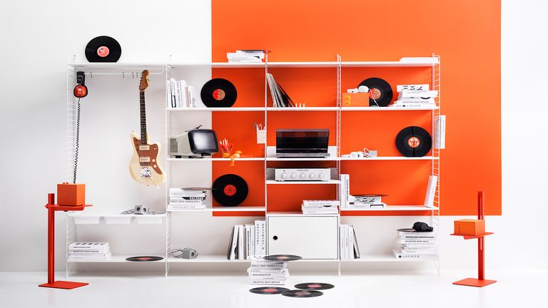 Record player stands String Furniture at Utility Design showing the shelving system against an orange and white wall