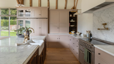 a cashmere classic barn kitchen with a range hob and marble counters