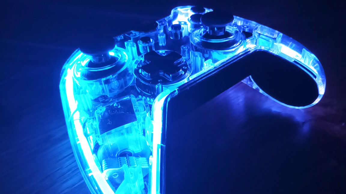 A photo of a game controller glowing blue