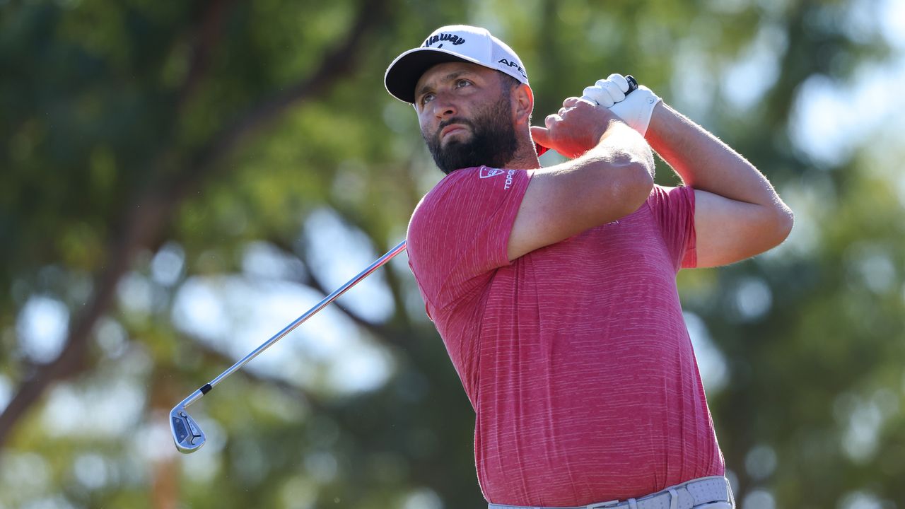 Jon Rahm hits an iron shot