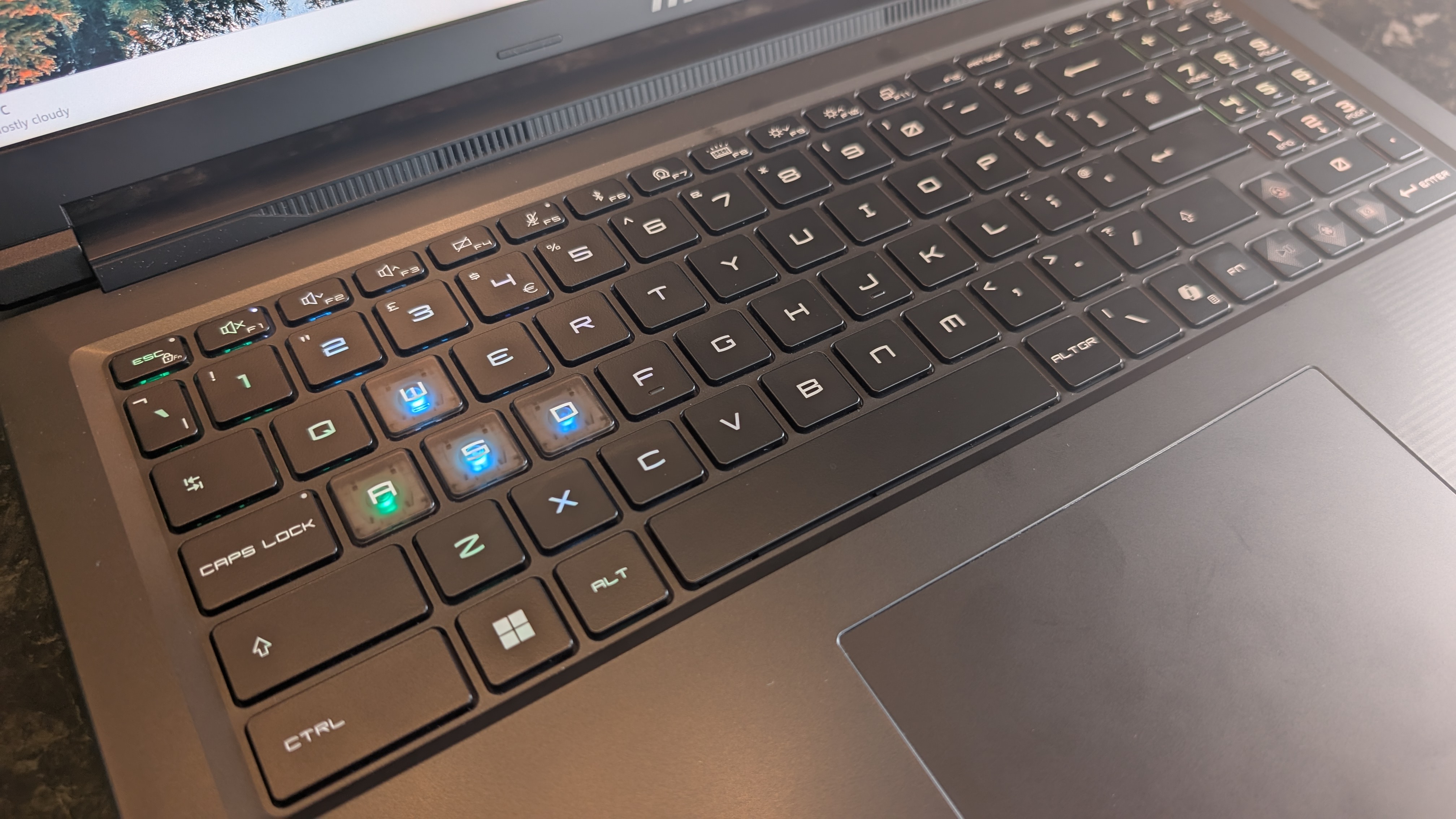 The MSI Raider 16 Max HX gaming laptop pictured on a black marble worktop.