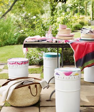Garden stools made from oil drums with colorful seat pads