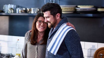 Couple in kitchen laughing together