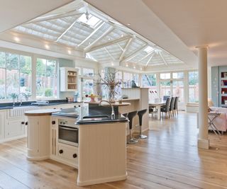 multi-height kitchen island in large kitchen conservatory extensions with roof-blinds