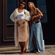 two fashion week attendees smiling at each other