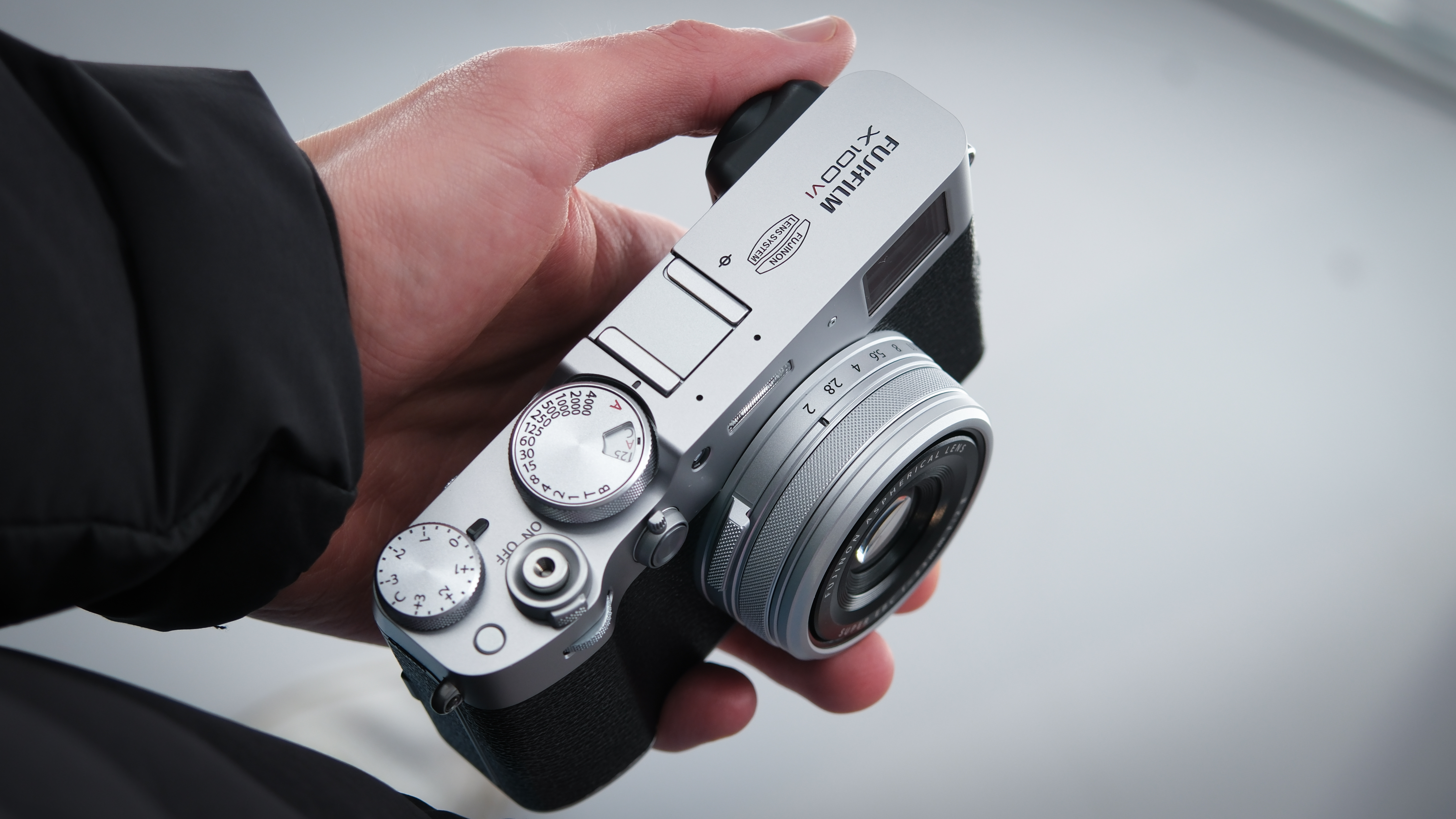 Man holding a Fujifilm X100 VI compact camera in  one hand