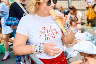 A fan enjoys an ice lolly as Swifties arrive to attend the concert of US singer and songwriter Taylor Swift as part of her 'Eras Tour' at Wembley Stadium, west of London, on June 21, 2024