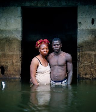 A man and a woman standing in water up to their waist