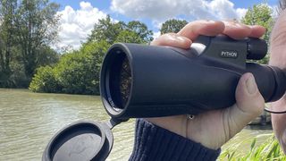 Python Rangemaster monocular showing the lens cap that falls out of the way when the monocular is in use.