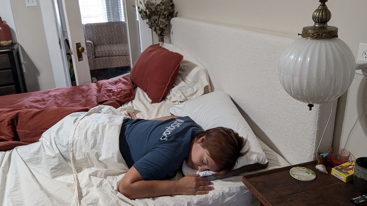 Reviewer Alex sleeping on the Sleep Number NaturalFit Ultimate Pillow