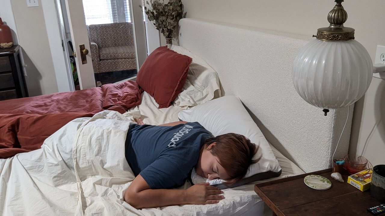 Reviewer Alex sleeping on the Sleep Number NaturalFit Ultimate Pillow